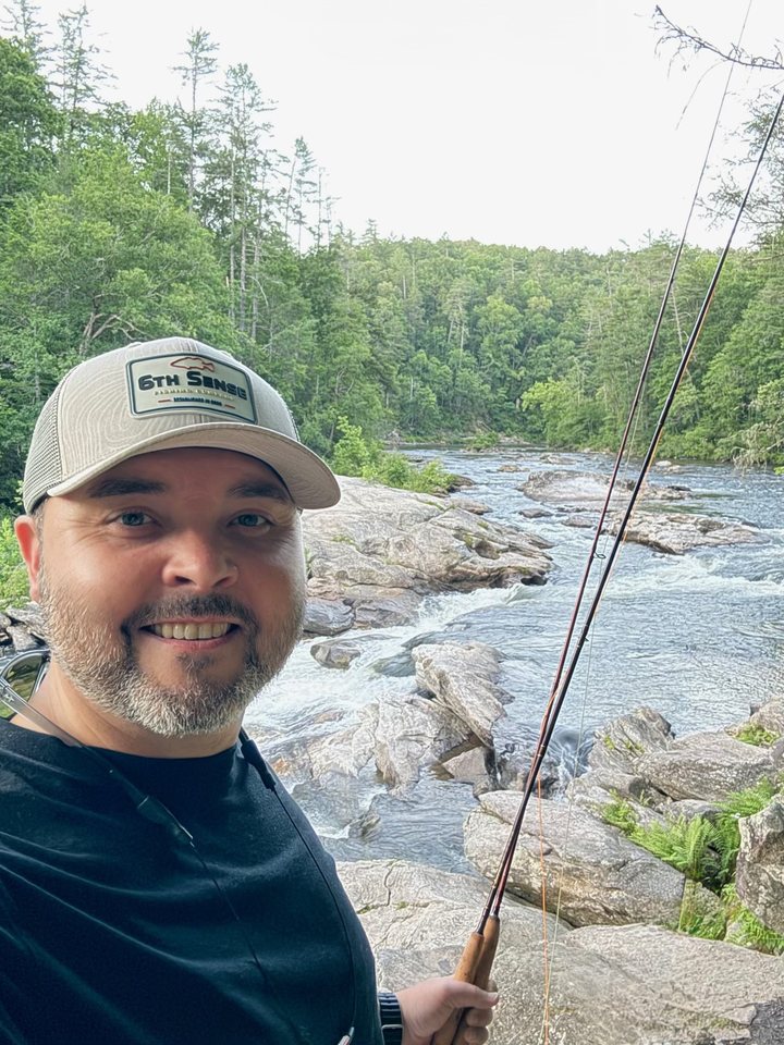 Rob Warfield, founder of ReviiewCo, fly fishing on a river in the Upstate